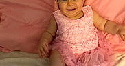 Laurabella is registered to the contest to win money with this photo: baby, girl, pink_dress, headband, smiling, sitting, pink_background, shoes, sock, cute, child, infant, happy, portrait, indoors, soft_surface, colorful_shoes, fabric, apparel, person