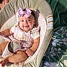 Charlotte is registered to the contest to win money with this photo: baby, bow, smile, infant, baby_seat, cushion, pink, clothing, happy, portrait, child, face, headband, fabric, blanket, indoor, cute, small_person, comfort, relaxation
