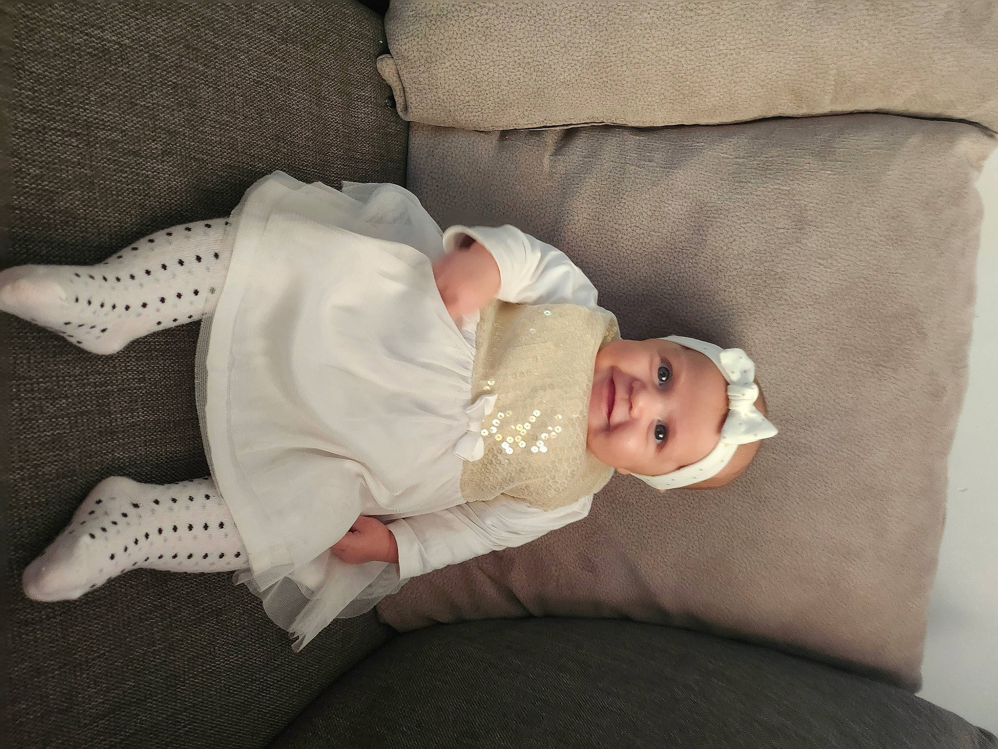 Eva participe au concours pour gagner de l'argent avec cette photo : arm, baby, baby_products, baby_toddler_clothing, comfort, dress, eye, glasses, hand, hat, head, headgear, headwear, human_body, joy, leg, linens, person, sleeve, smile
