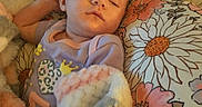 Amara joined the competition — help win amazing prizes! baby, sleeping, blanket, pillow, floral_pattern, infant, rest, comfort, cute, soft_texture, indoors, peaceful, relaxation, child, person, head, clothing, pastel_colors, peace, nap