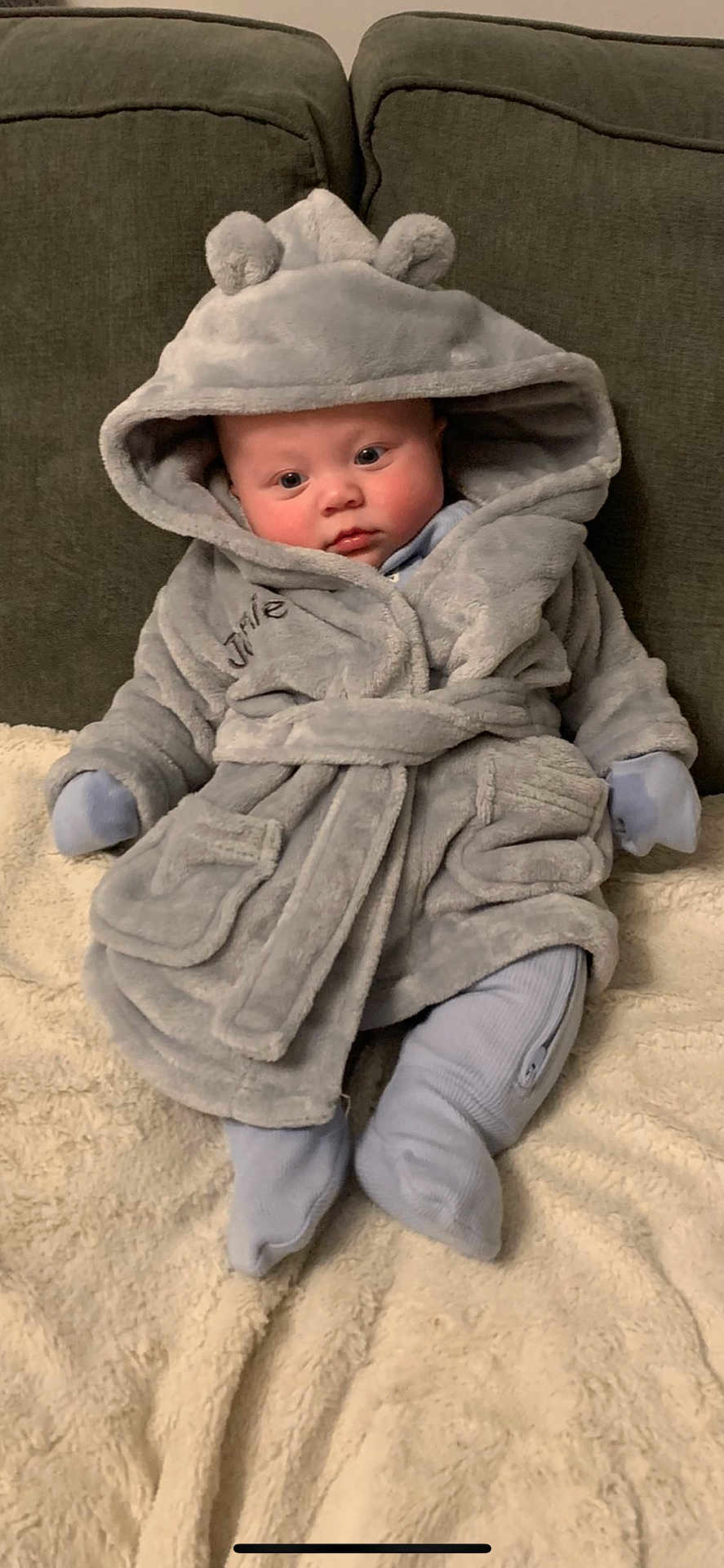 Jamie joined the competition — help win amazing prizes! baby, infant, robe, hood, ears, blanket, couch, soft, cozy, clothing, sitting, cute, face, expression, indoor, child, warm, comfort, person, portrait