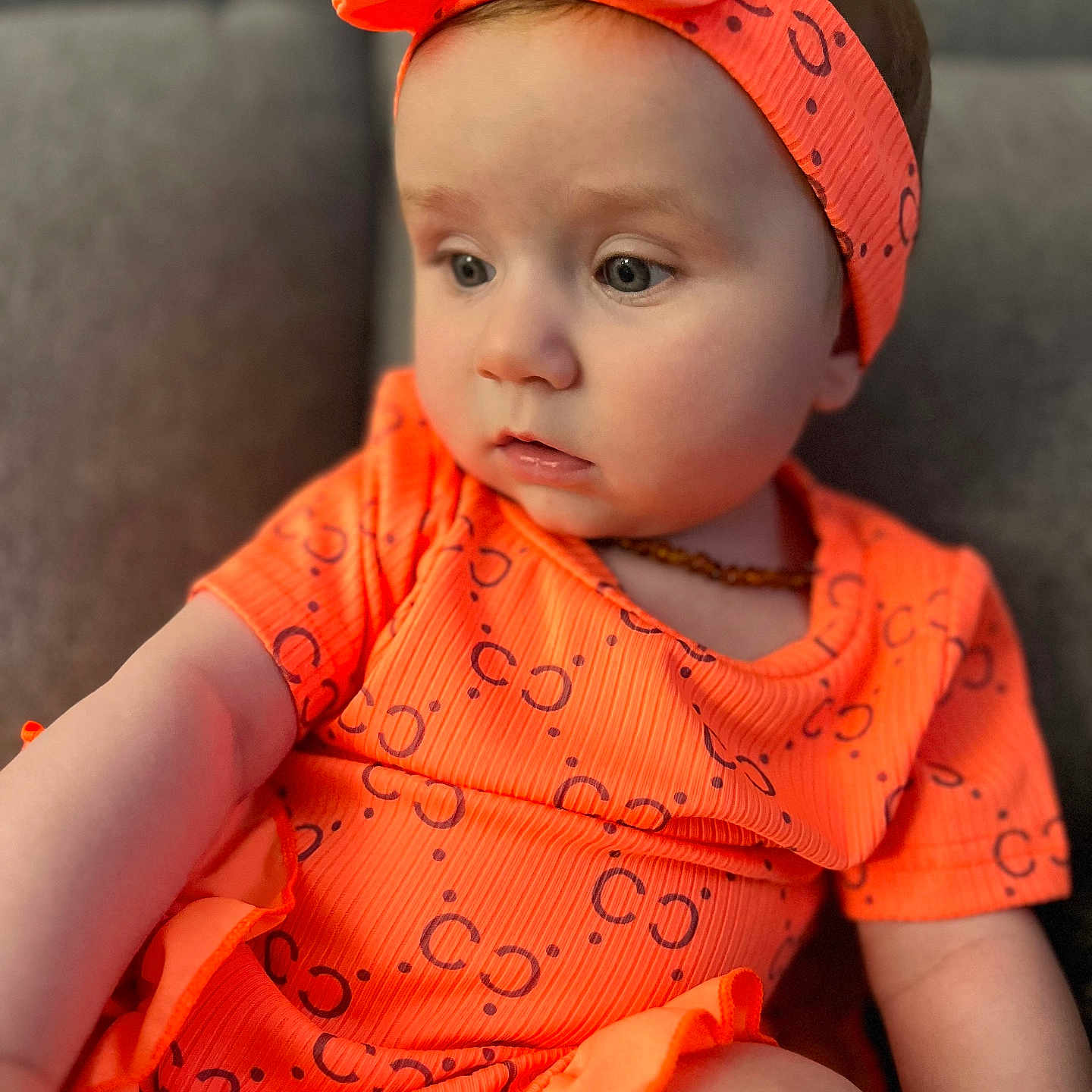 Syana participe au concours pour gagner de l'argent avec cette photo : accessories, baby, cap, clothing, couch, dress, face, furniture, happy, hat, head, headband, jewelry, necklace, person, photography, portrait, sitting, sleeve, smile