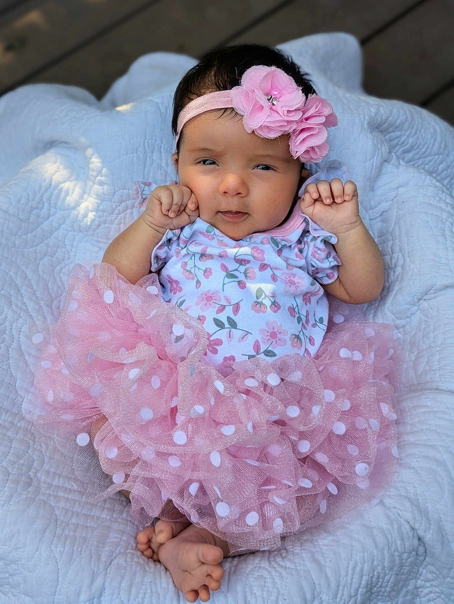 Annabel is registered to the contest to win money with this photo: baby, infant, pink, tutu, headband, flower, blanket, quilt, cute, clothing, polka_dot, onesie, feet, hands, portrait, outdoor, child, smile, face, newborn