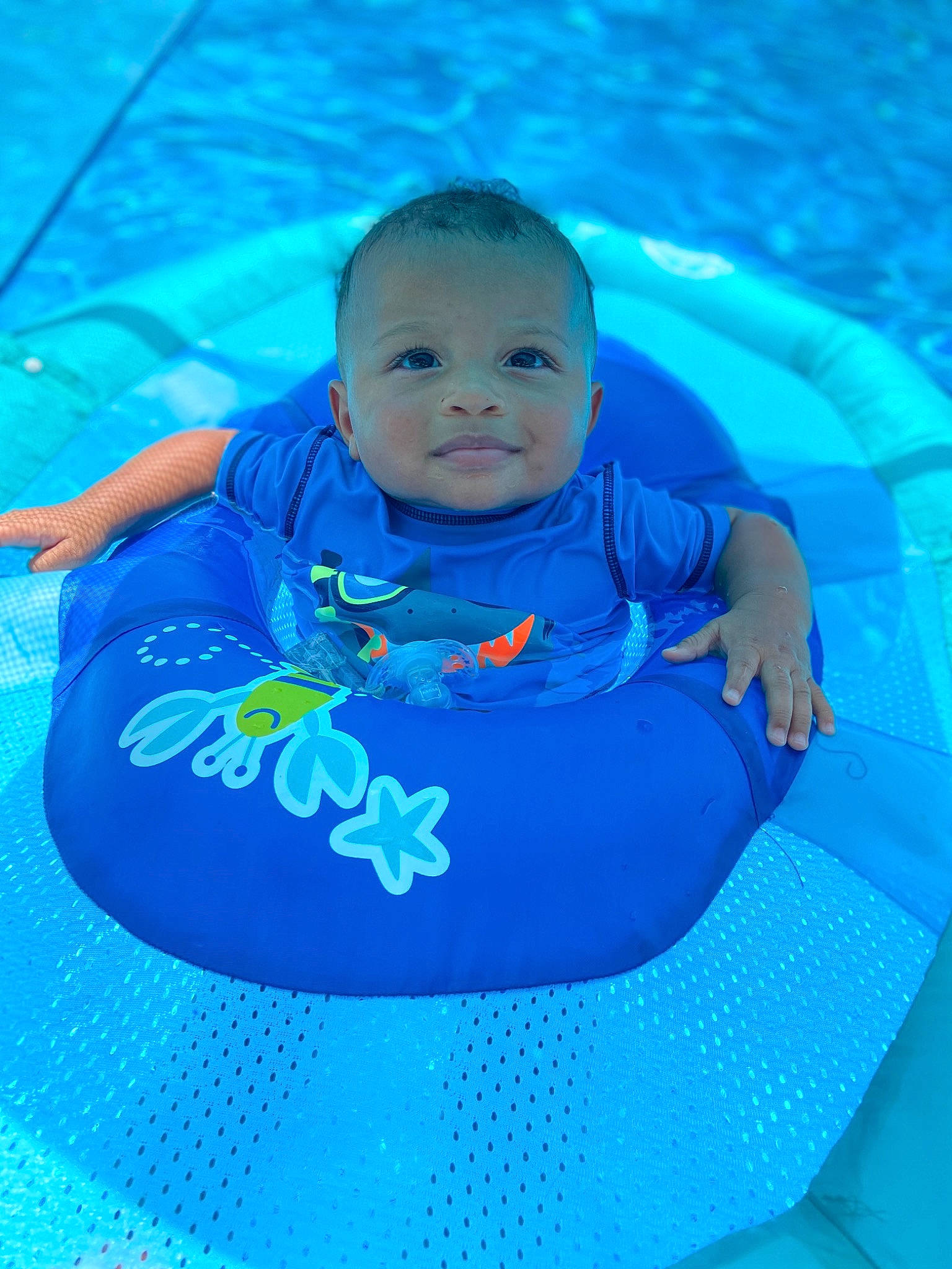 Desmond is registered to the contest to win money with this photo: aqua, baby, baby_float, baby_products, blue, child, fun, games, leisure, person, product, recreation, smile, swimming, swimming_pool, toddler, vacation