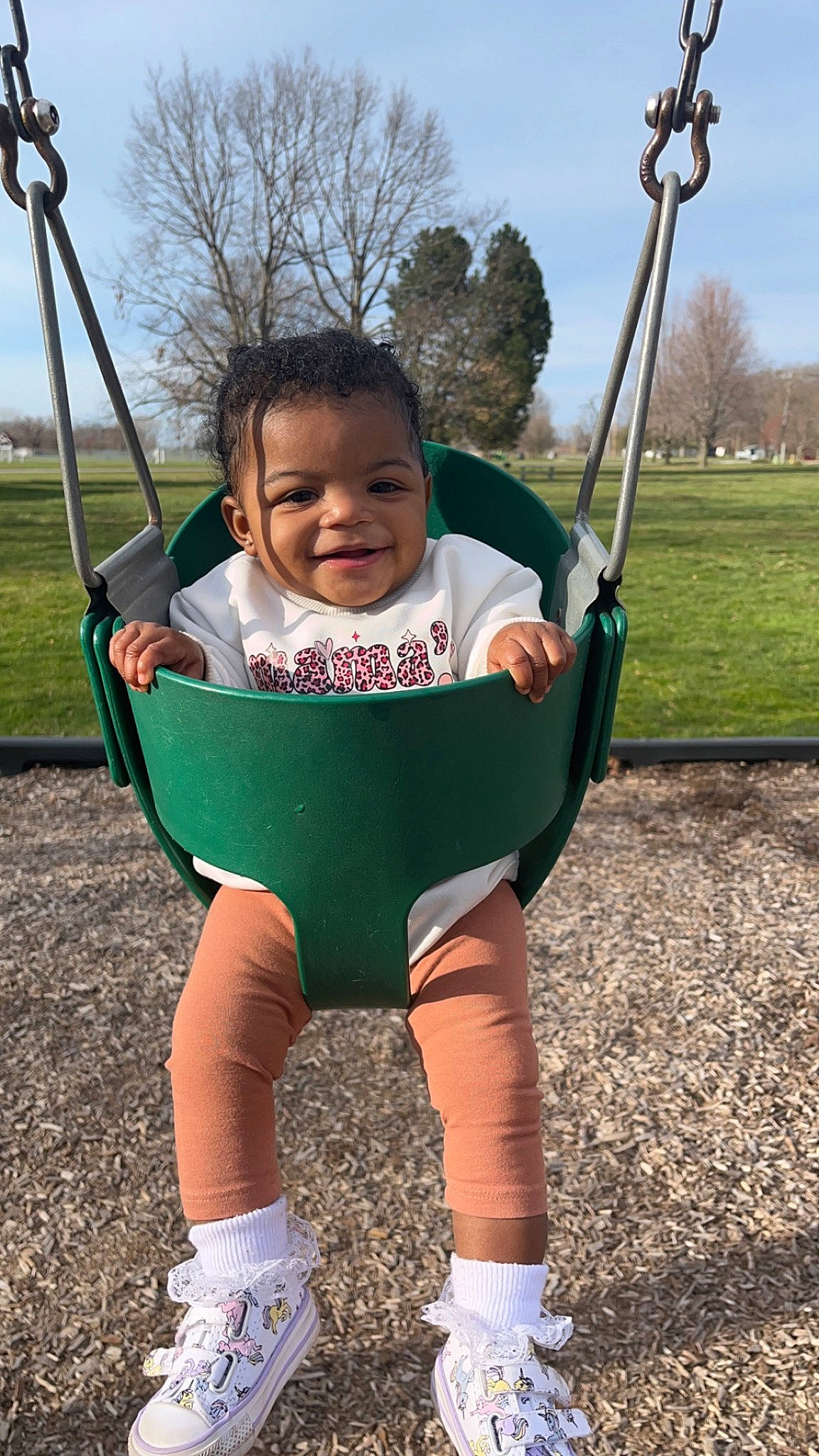 Alayah joined the competition — help win amazing prizes! baby, baby_toddler_clothing, cloud, grass, happy, human_body, joy, leisure, outdoor_play_equipment, people_in_nature, person, plant, playground, recreation, sky, sleeve, smile, swing, t_shirt, toddler