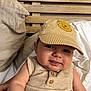 Marius participe au concours pour gagner de l'argent avec cette photo : baby, child, cap, striped_cap, beige_clothing, sleeveless, smile, tongue, bed, pillow, wooden_headboard, indoor, person, cute, infant, face, headwear, resting, comfort, sleepwear