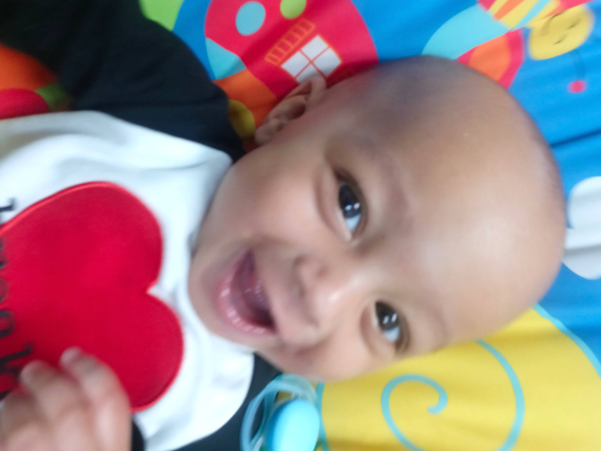 Keziah joined the competition — help win amazing prizes! baby, baby_playing_with_toys, cheek, chin, eye, face, facial_expression, fun, happy, head, iris, joy, lip, mouth, nose, person, product, red, skin, smile