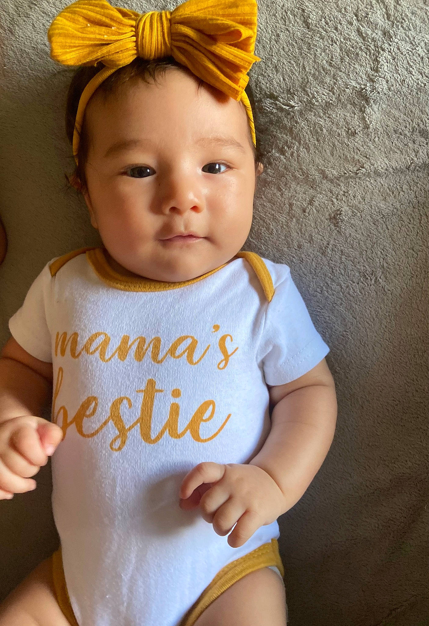 Malani is registered to the contest to win money with this photo: baby, baby_toddler_clothing, cheek, chin, eye, eyelash, face, hair, hairstyle, hand, happy, head, human_body, lip, neck, outerwear, person, skin, sleeve, white