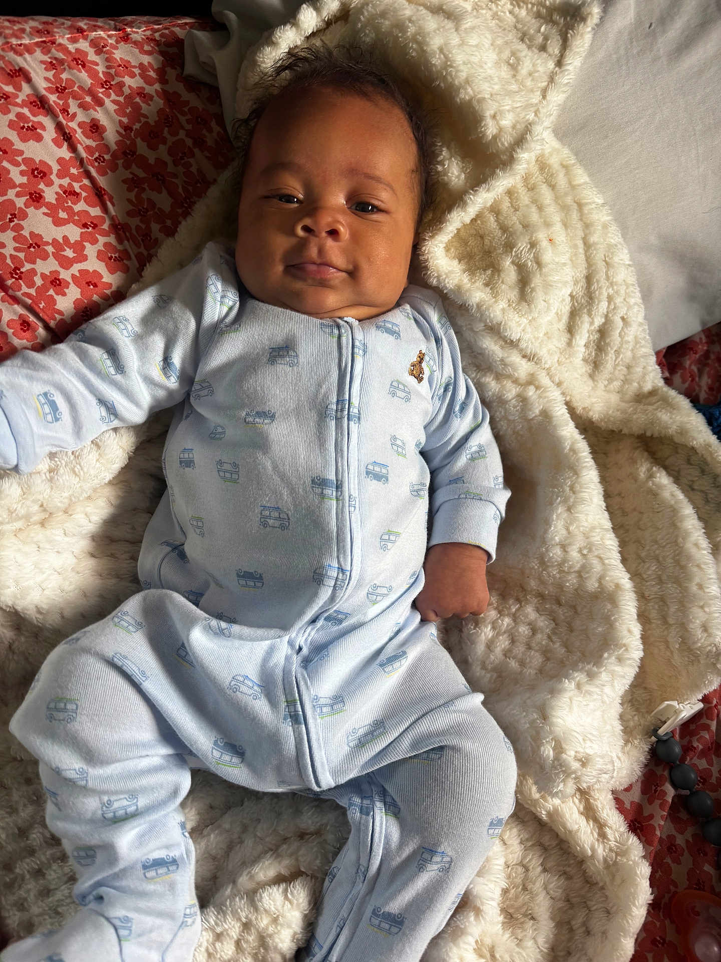 Xonyx is registered to the contest to win money with this photo: baby, infant, pajamas, blanket, bed, pillow, floral_pattern, face, sleepwear, person, cozy, indoors, child, cute, soft_texture, lying_down, comfort, relaxing, home, blanket_texture