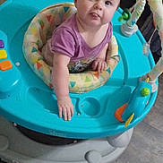 Lena joined the competition — help win amazing prizes! baby, child, walker, purple_shirt, toy, floor, indoor, play, infant, cute, childhood, furniture, expression, tongue_out, colorful, seat, person, young, happy, looking_up
