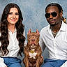 blue_pants, casual, collar, dog, fashion, friendship, glasses, indoor, jewelry, man, name_tag, people, pet, pitbull, portrait, sitting, smiling, studio, white_shirt, woman