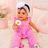 baby, child, infant, portrait, smiling, sitting, pink_outfit, dress, headband, flower, daisy, floral, shoes, rug, pillow, cushion, indoor, pastel, nursery, cute