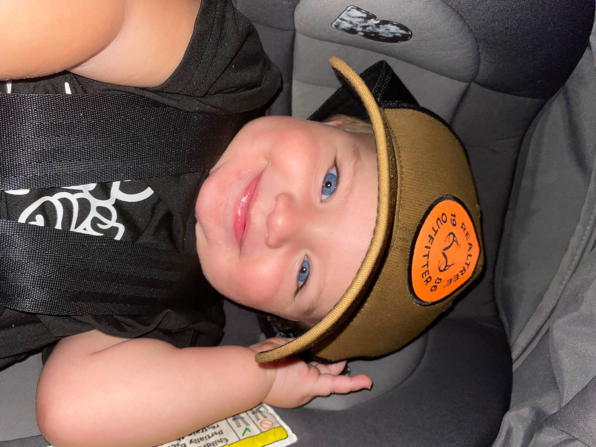Thorin is registered to the contest to win money with this photo: auto_part, car_seat, chest, child, comfort, elbow, eyelash, fun, gesture, happy, headwear, human_body, joy, mouth, neck, person, personal_protective_equipment, smile, t_shirt, thigh
