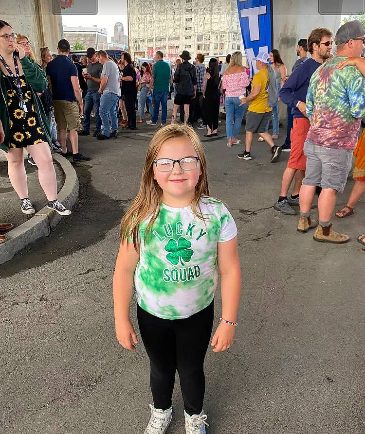 Ariel is registered to the contest to win money with this photo: asphalt, city, clothing, event, eyewear, fun, happy, joy, leisure, pedestrian, person, recreation, road, shoe, shorts, shoulder, sneakers, street, t_shirt, thigh