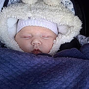 Louise participe au concours pour gagner de l'argent avec cette photo : baby, sleeping, blanket, hat, hood, cozy, face, infant, child, warm, cute, soft, snug, portrait, closeup, bundle, sleep, peaceful, apparel, rest