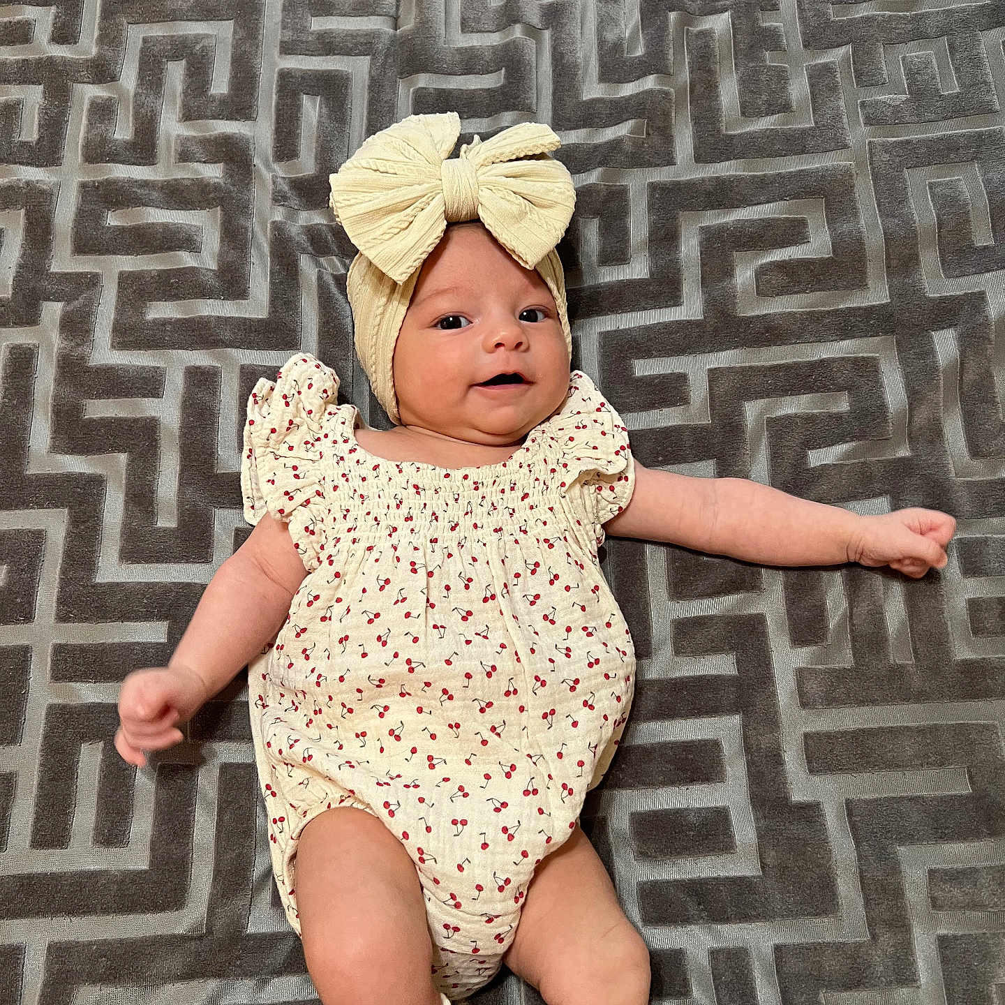 Isabella joined the competition — help win amazing prizes! baby, bonnet, cap, clothing, costume, crying, dress, face, hat, head, lady, newborn, pants, pattern, person, photography, portrait, sad, shorts, sitting