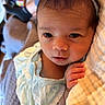 baby, infant, child, headband, blue_bow, blue_dress, blanket, hand, face, eyes, indoor, person, laptop, sock, legs, soft_texture, curious, resting, cozy, home