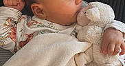 Esme joined the competition — help win amazing prizes! baby, bed, blanket, child, clothing, comfort, cuddle, cute, expression, face, hand, indoor, infant, lying_down, portrait, rest, sleepwear, soft_toy, stuffed_animal, warm