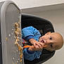 Léon participe au concours pour gagner de l'argent avec cette photo : baby, blue_clothing, child, curious, expression, face, feeding, food, head, high_chair, indoor, infant, light_skin, mealtime, messy, person, seated, spoon, table, tray