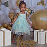 toddler, child, birthday, dress, balloons, gift_boxes, floor, hair_clips, party, celebration, smiling, indoor, decorations, gold, white, blue, cute, barefoot, girl, portrait
