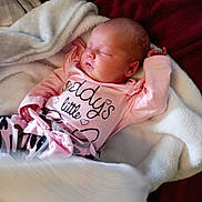 Lila is registered to the contest to win money with this photo: baby, sleeping, pink_clothing, blanket, soft, cozy, infant, newborn, face, hand, footwear, sock, rest, cute, child, portrait, indoors, fabric, relaxation, peaceful