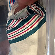 Raelynn is registered to the contest to win money with this photo: newborn, baby, sleeping, swaddled, blanket, striped, hat, hospital, bassinet, infant, face, peaceful, child, portrait, soft_light, clothing, cute, resting, wrapped, person