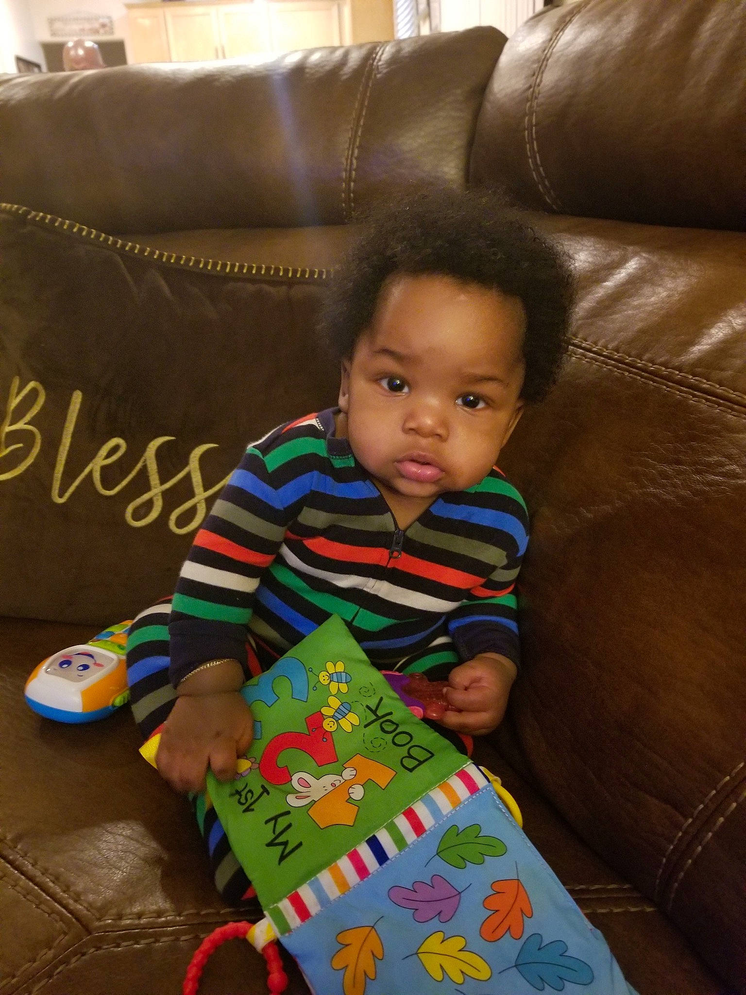 Richie joined the competition — help win amazing prizes! baby, baby_toddler_clothing, black, carmine, child, comfort, couch, flooring, fun, hardwood, holiday, lap, linens, living_room, person, room, sitting, sleeve, textile, toddler