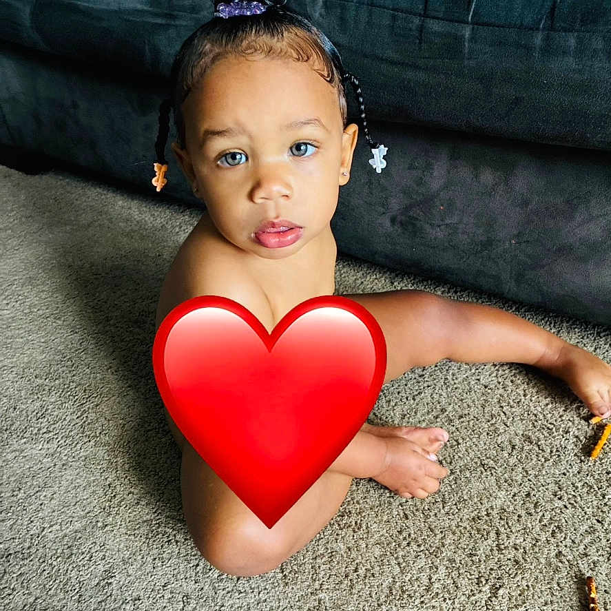 Kyelle is registered to the contest to win money with this photo: child, toddler, portrait, sitting, carpet, couch, indoor, home, face, eyes, braids, hair_accessories, heart_sticker, privacy_cover, bare_shoulders, floor, furniture, photography, centered, colorful