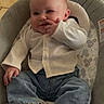Clayton participe au concours pour gagner de l'argent avec cette photo : baby, child, infant, cute, smiling, white_shirt, blue_jeans, white_shoes, baby_seat, indoor, tiled_floor, cushion, playful, finger_near_nose, person, young_child, happy, casual_clothing, text_overlay, love