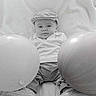 Clayton participe au concours pour gagner de l'argent avec cette photo : baby, balloon, cap, child, clothing, cute, face, footwear, infant, indoors, monochrome, person, portrait, sitting, shoes, soft_blanket, toy, young_child, blanket, comfortable