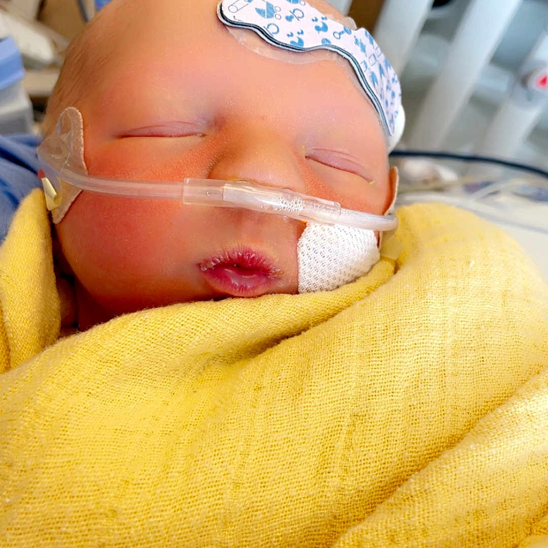 Kayson joined the competition — help win amazing prizes! architecture, baby, bed, blanket, building, clothing, crib, face, furniture, glove, head, hospital, infantbed, machine, newborn, person, photography, portrait, sleeping, wheel