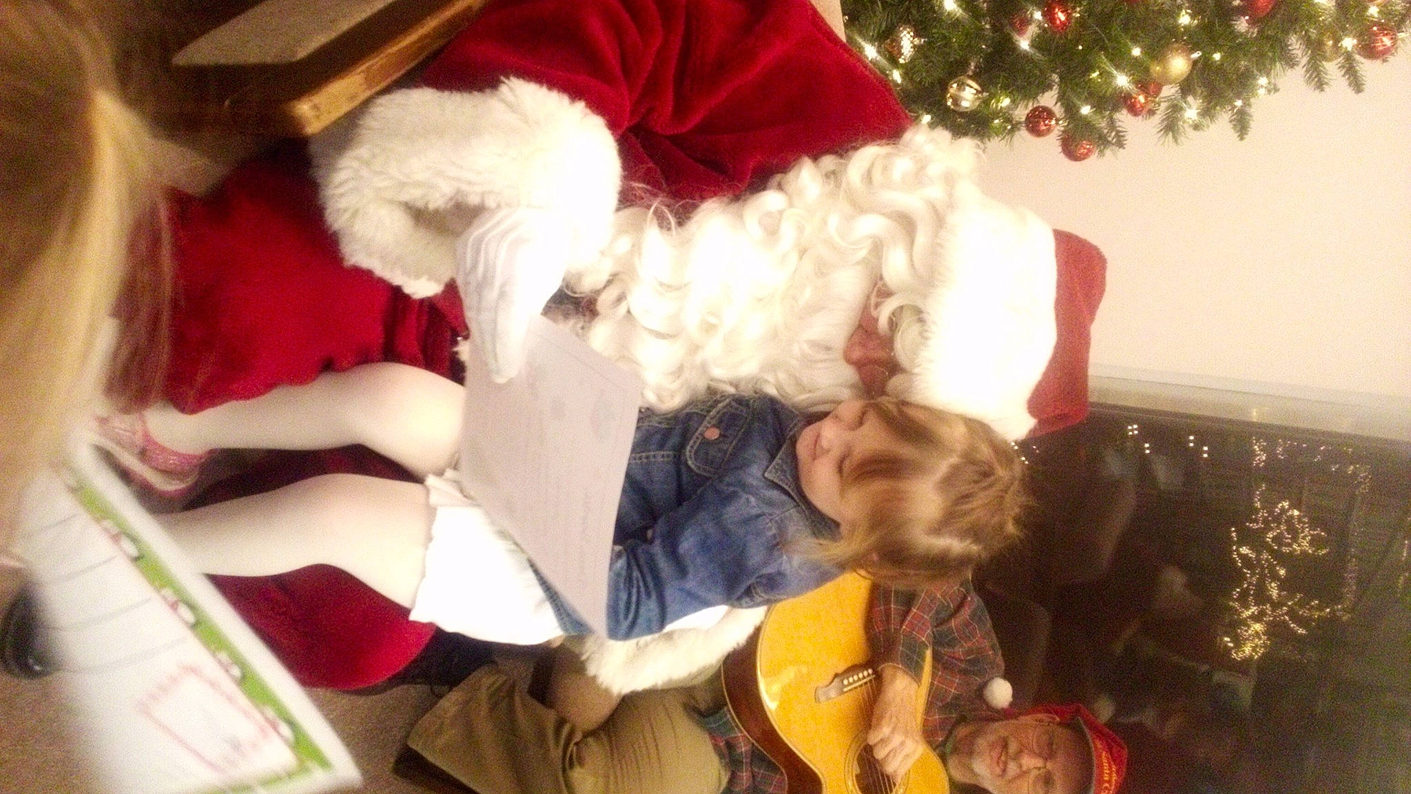 Dallas joined the competition — help win amazing prizes! baby, christmas, christmas_decoration, christmas_eve, christmas_ornament, christmas_tree, conifer, event, fictional_character, fun, fur, happy, headwear, holiday, interior_design, lap, ornament, person, room, santa_claus