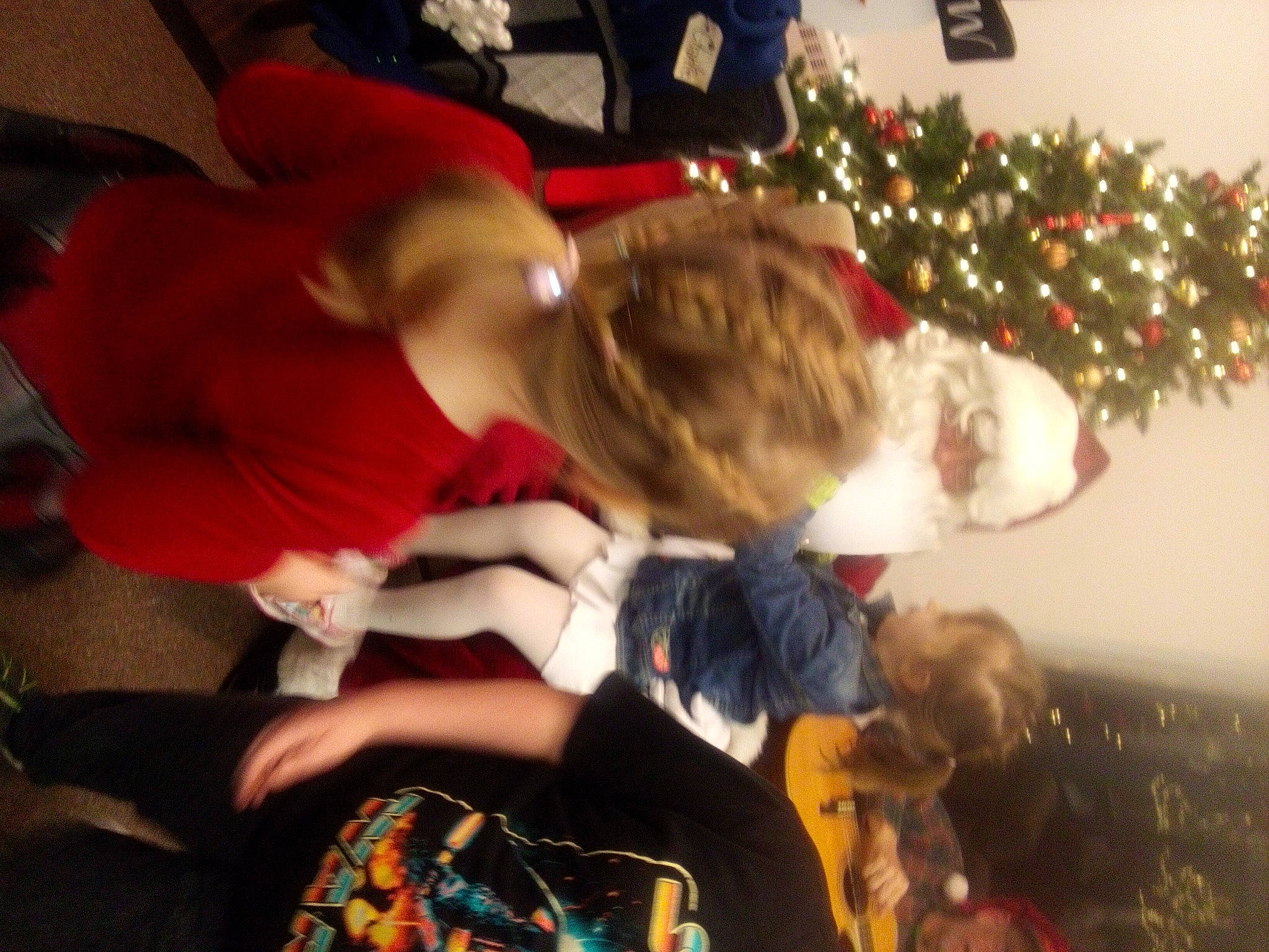 Dallas is registered to the contest to win money with this photo: child, christmas, christmas_decoration, christmas_eve, christmas_ornament, christmas_tree, conifer, event, fun, happy, holiday, lap, ornament, person, plant, room, sitting, t_shirt, tartan, tradition