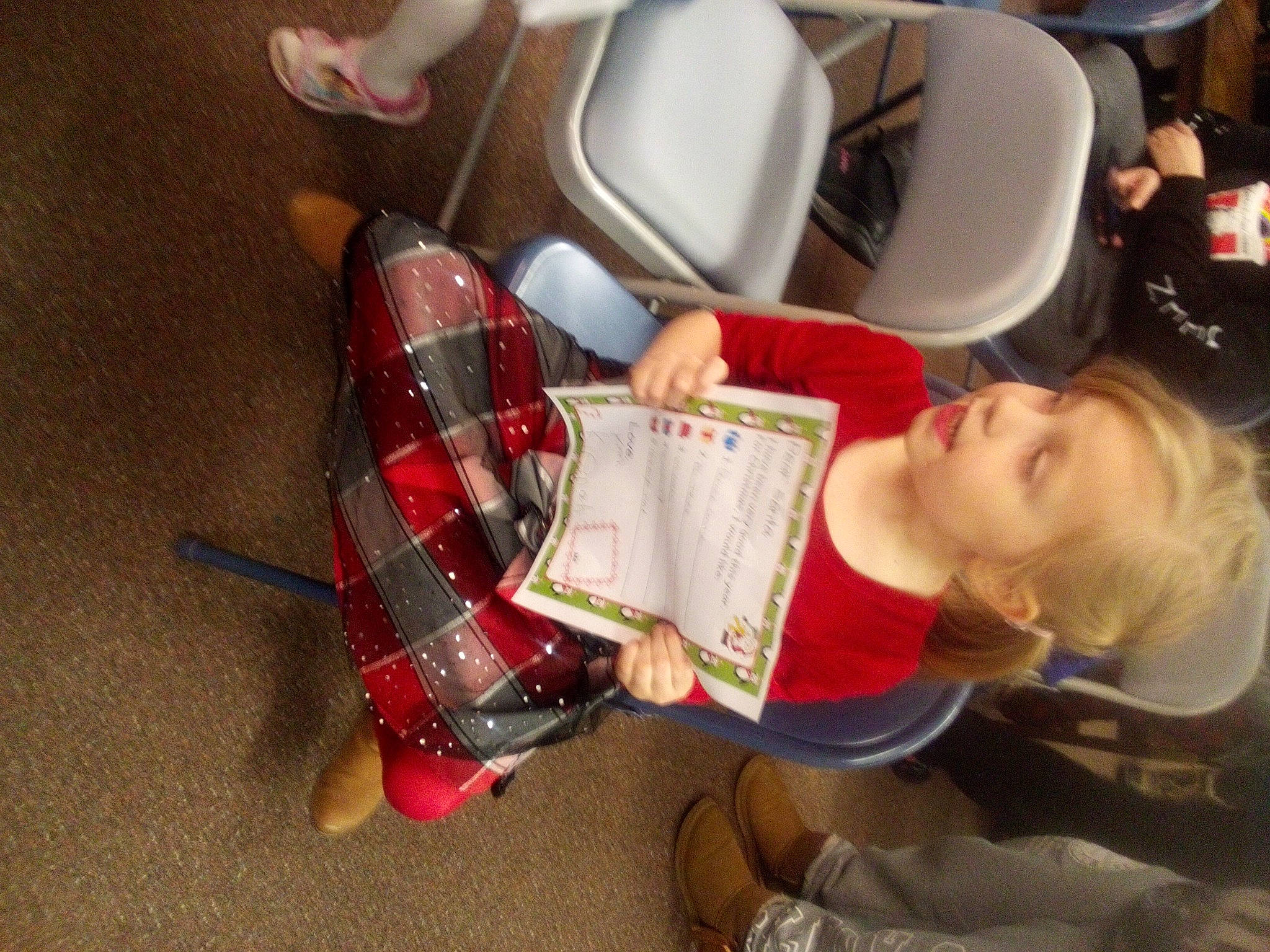 Kierah is registered to the contest to win money with this photo: carmine, chair, child, drinkware, flooring, fun, human_leg, kitchen_appliance, pattern, person, personal_protective_equipment, plaid, room, sandal, shoe, sitting, sneakers, sock, tartan, toddler