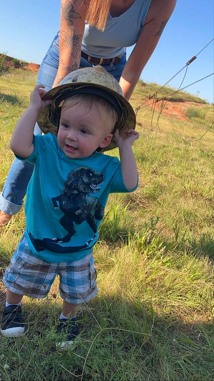Sawyer is registered to the contest to win money with this photo: baby_toddler_clothing, child, fun, grass, grass_family, grassland, happy, hat, landscape, lawn, meadow, nature, people_in_nature, person, plant, shorts, sky, sleeve, sun_hat, toddler