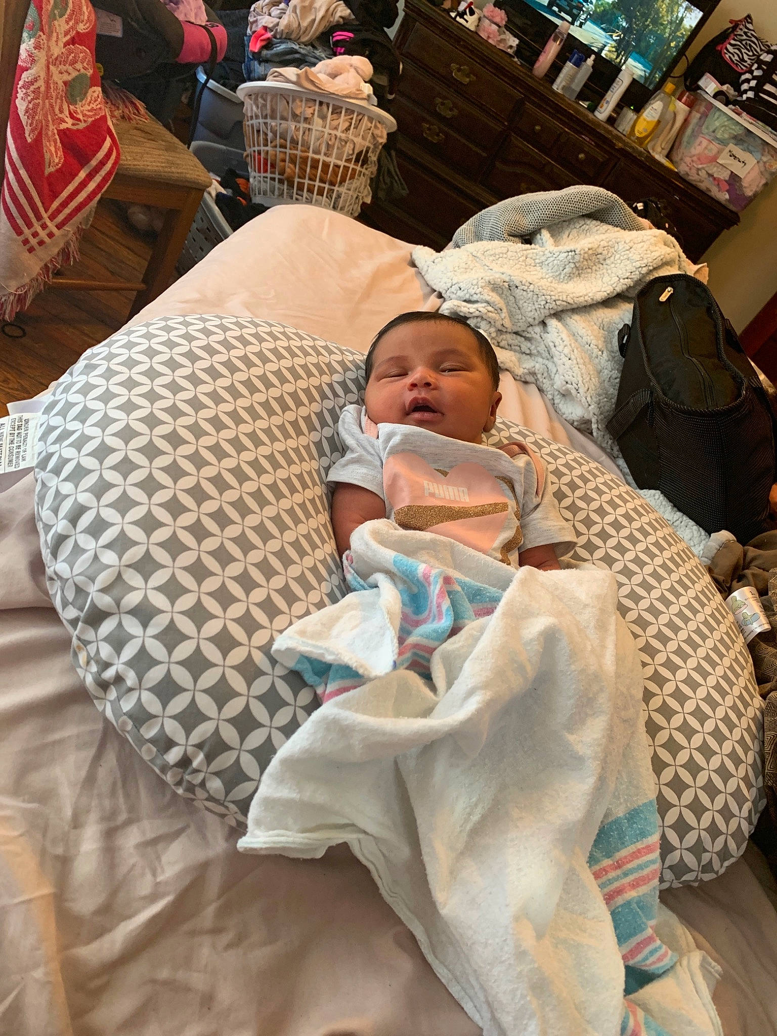 Shyanna is registered to the contest to win money with this photo: baby, baby_products, baby_safety, bedding, child, comfort, event, hospital, infant_bed, linens, pattern, person, room, service, sitting, throw_pillow, toddler, vacation