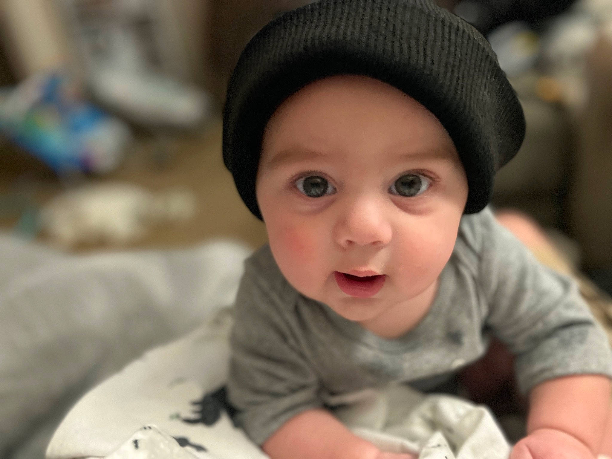 Ezra is registered to the contest to win money with this photo: baby, baby_toddler_clothing, cap, cheek, child, chin, comfort, eye, eyebrow, fashion_accessory, flash_photography, fun, happy, hat, headwear, lip, nose, person, sitting, skin