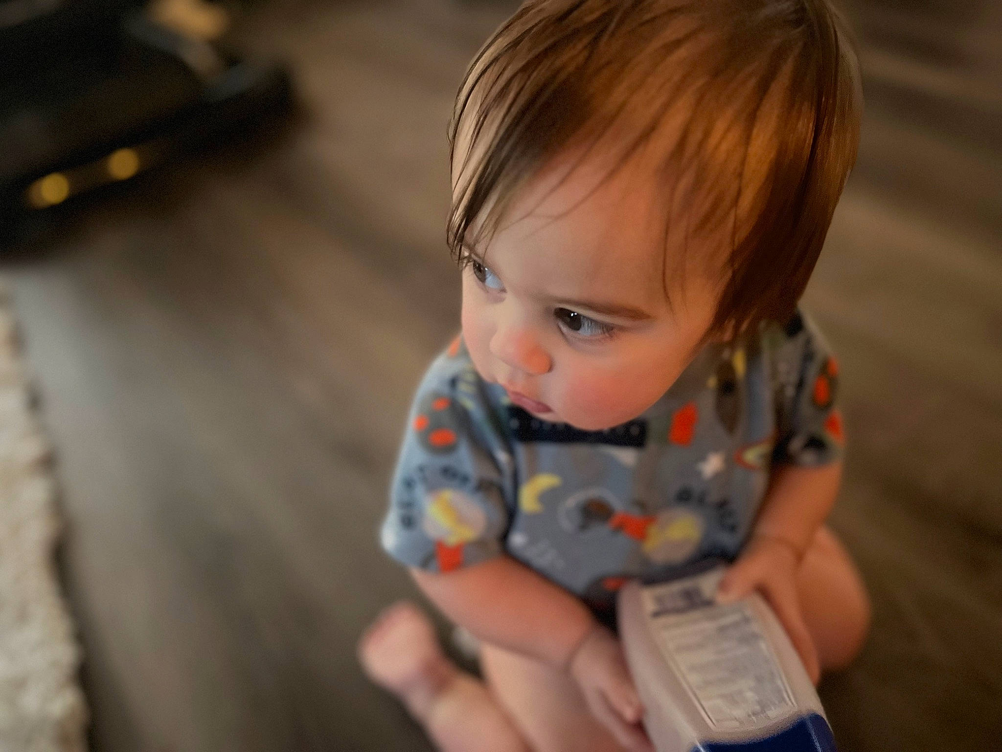 Ezra is registered to the contest to win money with this photo: baby, baby_toddler_clothing, cheek, child, chin, eye, face, flooring, fun, happy, hardwood, head, iris, nose, person, play, sitting, skin, toddler, vacation