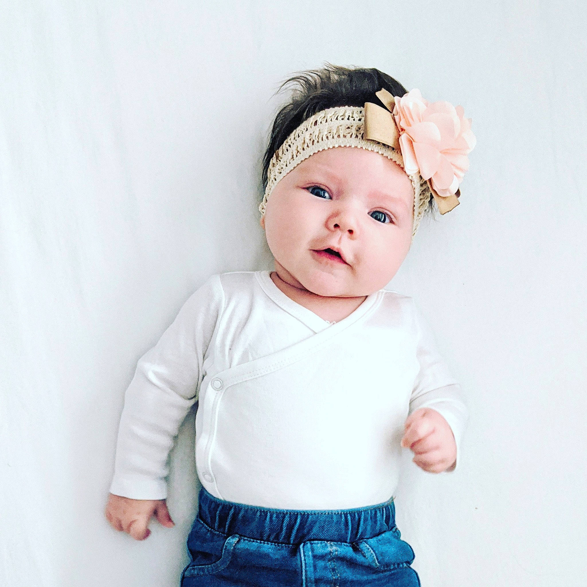 Mara is registered to the contest to win money with this photo: arm, baby, baby_toddler_clothing, cheek, child, child_model, clothing, face, fashion_accessory, hair_accessory, head, headband, headgear, headpiece, headwear, outerwear, person, pink, skin, sleeve