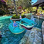 toddler, child, inflatable, dinosaur, pool, water, swimming_pool, float, outdoor, summer, sunny, trees, greenery, vacation, relaxation, steps, resort, blue_sky, casual_clothing, playful