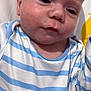 Noah joined the competition — help win amazing prizes! baby, infant, face, close_up, striped_clothing, blue, white, blanket, sleepy, indoors, human, child, cute, skin, head, expression, soft, young, portrait, person
