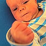 baby, infant, child, face, hand, fist, blue_background, striped_clothing, closeup, portrait, cute, soft_skin, lying_down, young_child, apparel, baby_clothes, young_infant, person, human, indoor