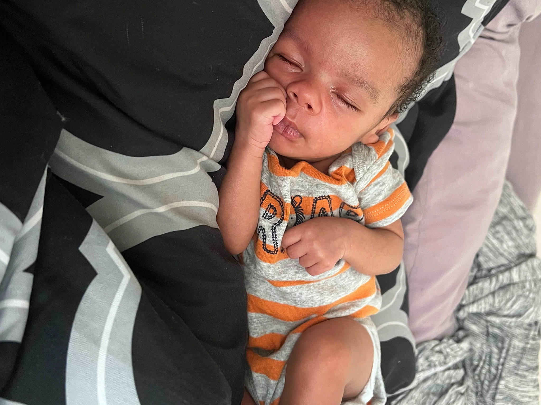 Kareem is registered to the contest to win money with this photo: baby, baby_toddler_clothing, child, comfort, facial_expression, finger, fun, gesture, hairstyle, hand, happy, human_leg, interaction, lap, mouth, person, product, skin, thigh, toddler