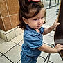 Isabel Escobedo is registered to the contest to win money with this photo: toddler, child, denim, blue_clothing, bow, hair_accessory, earrings, standing, chair, floor_tiles, shopping_mall, indoor, cute, pink_shoes, girl, person, holding, portrait, casual, curly_hair