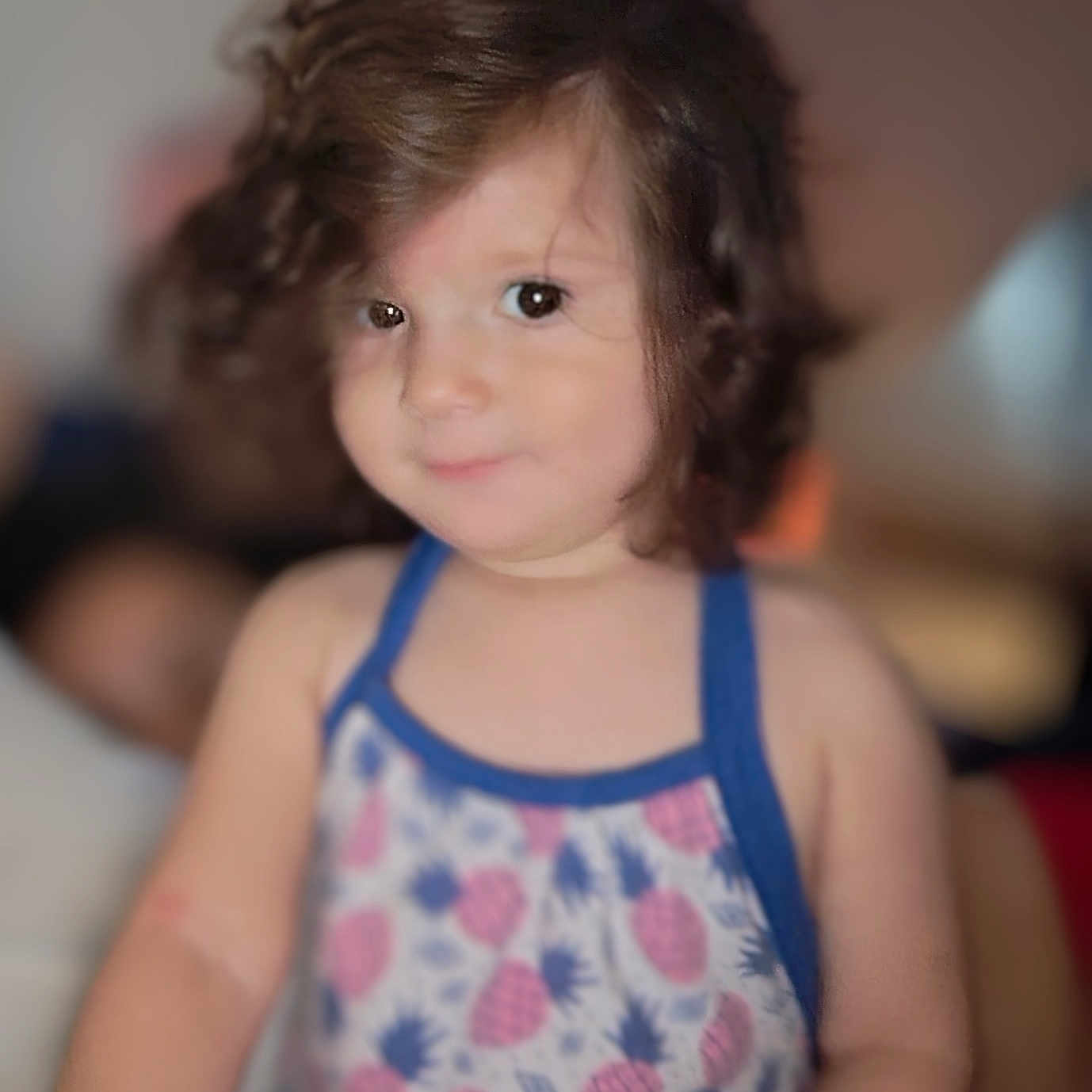 Isabel Escobedo joined the competition — help win amazing prizes! blurry_background, casual, child, curly_hair, cute, dress, eyes, face, indoor, patterned_clothing, person, pineapple_pattern, portrait, shoulders, skin, smile, soft_focus, toddler, warm_lighting, young_child