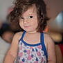 Gael Escobedo joined the competition — help win amazing prizes! child, toddler, curly_hair, dress, patterned_clothing, pineapple_pattern, smile, portrait, indoor, soft_focus, face, person, cute, young_child, skin, eyes, shoulders, blurry_background, warm_lighting, casual