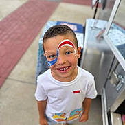 Adam joined the competition — help win amazing prizes! child, boy, face_paint, smile, outdoor, sidewalk, casual_clothing, shorts, white_tshirt, summer, happy, portrait, blue_eyes, short_hair, standing, colorful, footwear, concrete, fun, daytime
