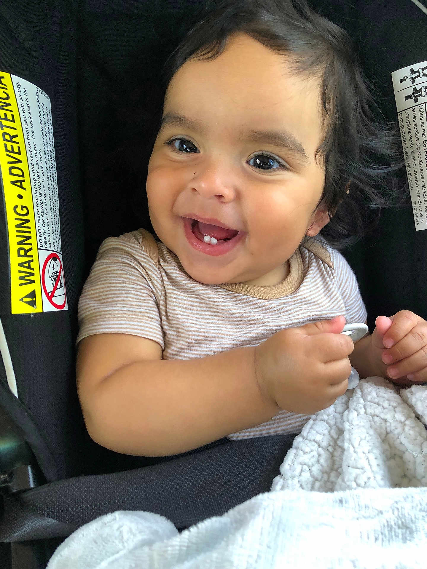 Asher joined the competition — help win amazing prizes! baby, child, smiling, face, eyes, teeth, pacifier, blanket, car_seat, clothing, infant, cute, happy, indoors, person, young_child, hair, skin, seatbelt, closeup