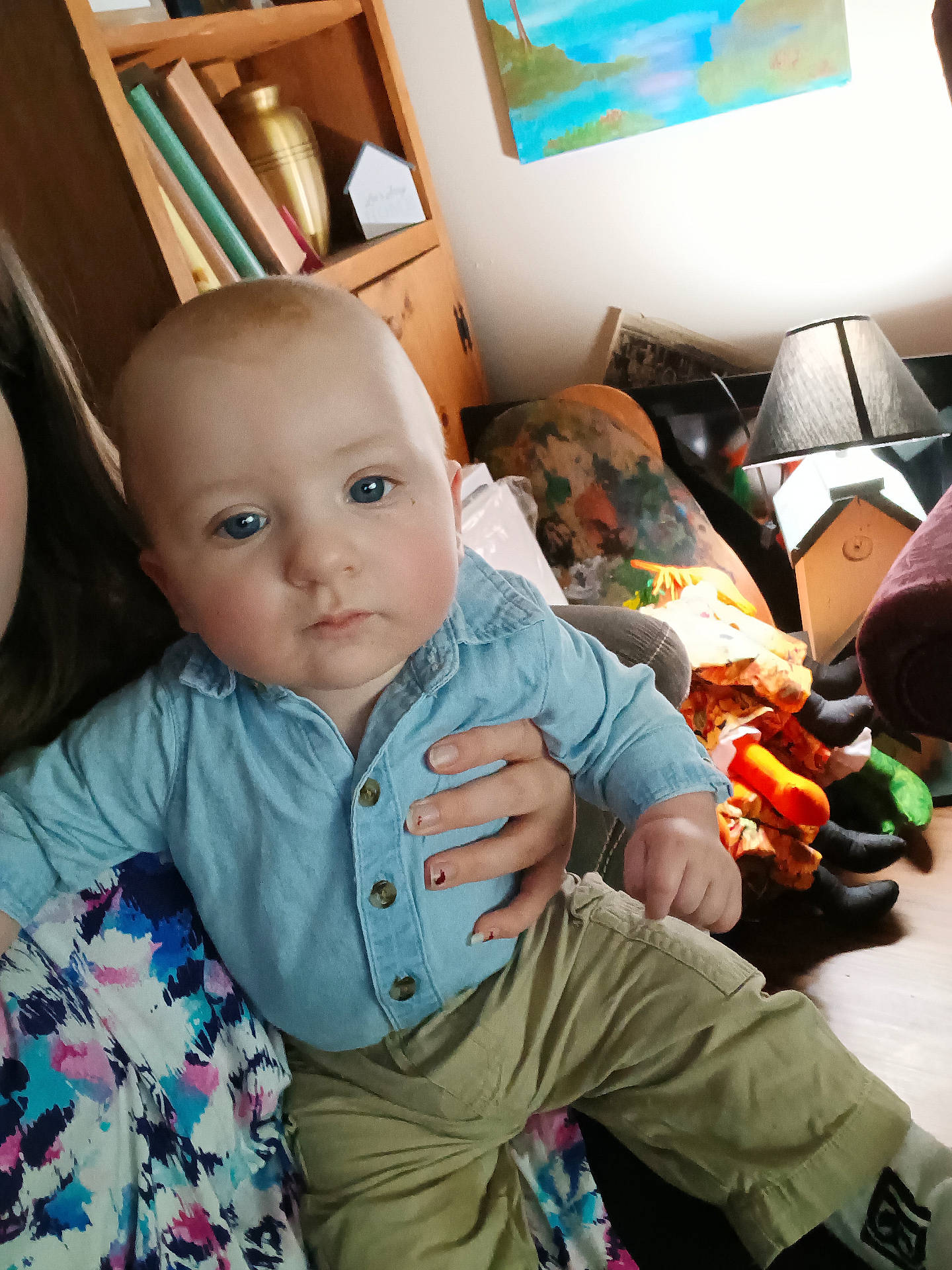 Phoenix is registered to the contest to win money with this photo: architecture, baby, bodypart, building, clothing, couch, face, finger, furniture, hand, head, indoors, lamp, livingroom, pants, person, photography, portrait, shelf, sitting