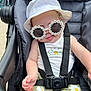 baby, stroller, sunglasses, hat, flower_pattern, child, summer, outdoor, cute, fashion, seatbelt, infant, sun_protection, casual, green, white, yellow, smiling, baby_clothes, accessory